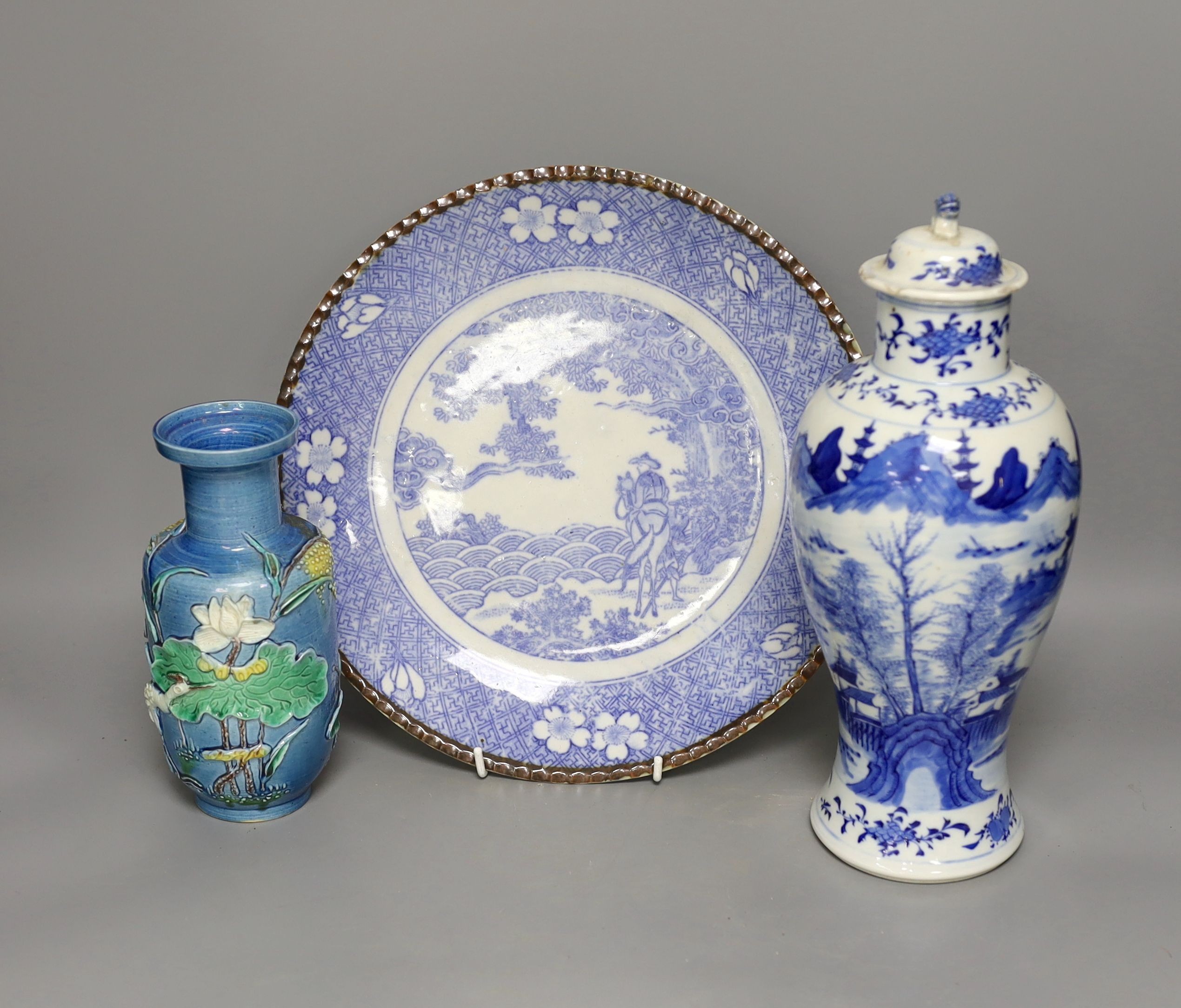 An early 20th century Chinese blue and white lidded vase together with a similar enamelled pottery vase and a Japanese blue and white dish. Tallest vase 29cm